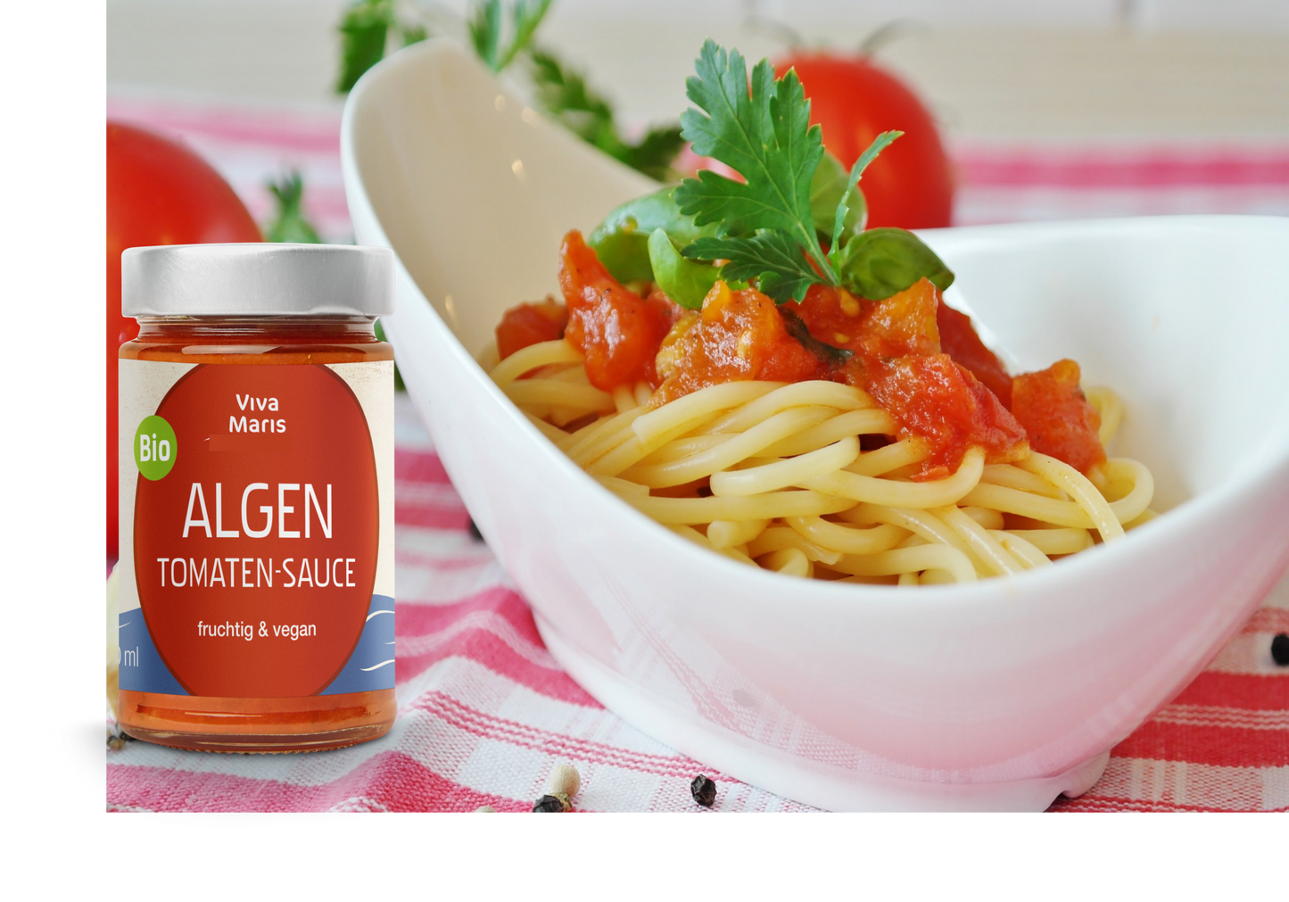 Bio Algen Tomaten-Sauce im Glas vor einem Schüssel mit Spaghetti und Algen Tomaten Sauce