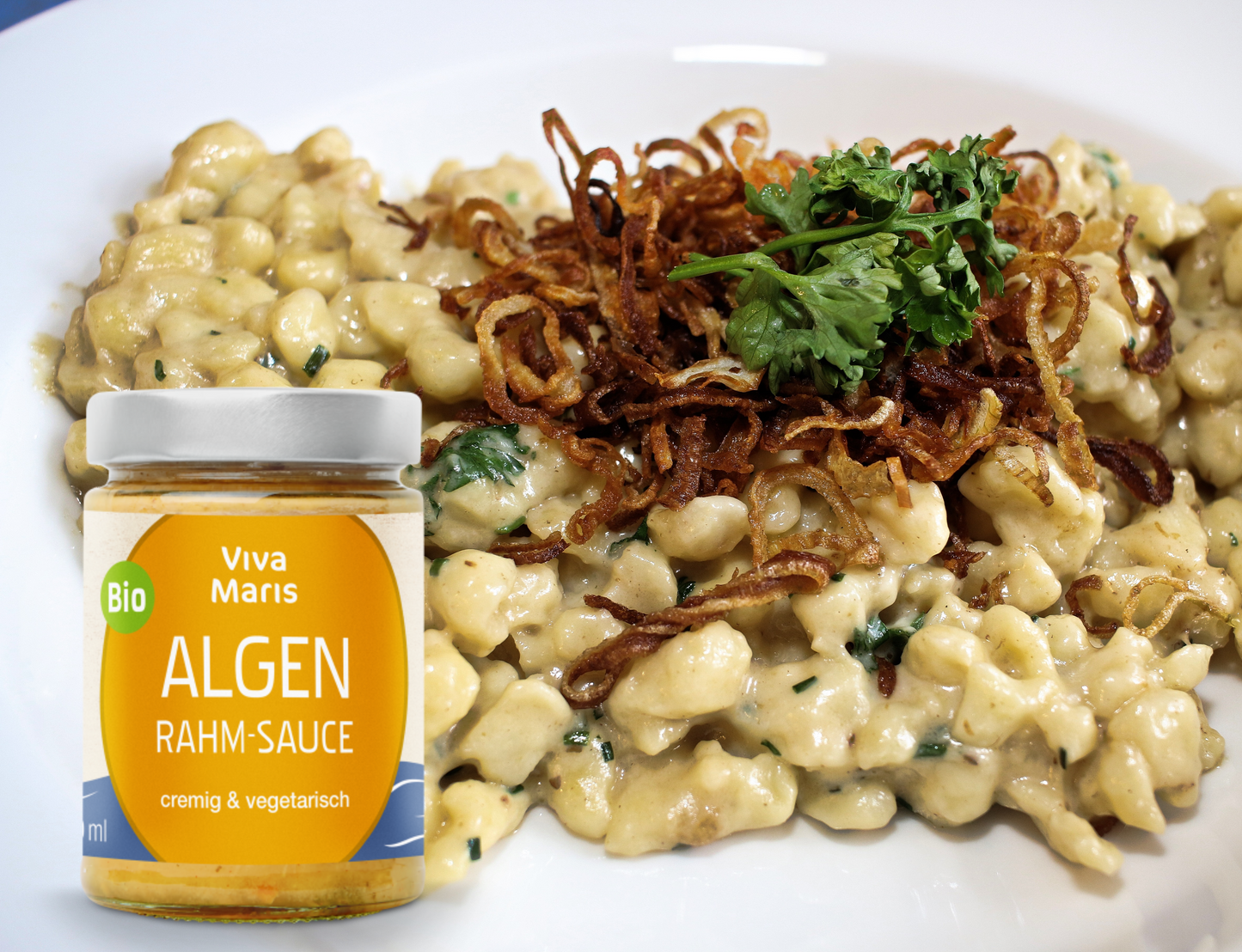 Bio Algen Rahm-Sauce im Glas vor einem Teller mit Spätzle und Algen Rahm Sauce und Röstzwiebeln